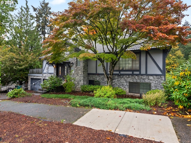 view of front of house featuring stone siding and stucco siding