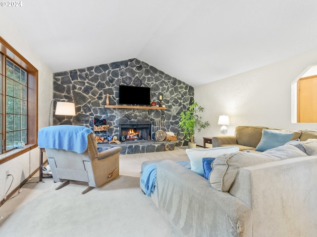 carpeted living area featuring lofted ceiling and a stone fireplace