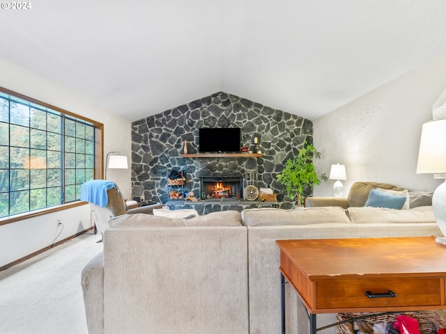 living room with lofted ceiling, a stone fireplace, baseboards, and light colored carpet