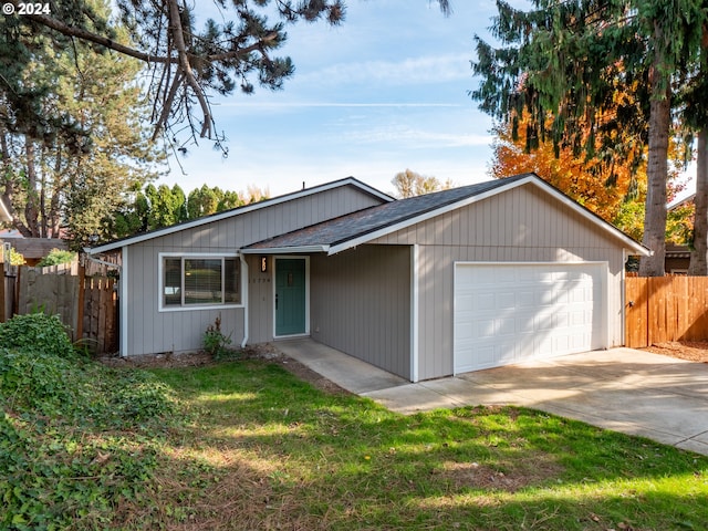 single story home featuring a front yard and a garage