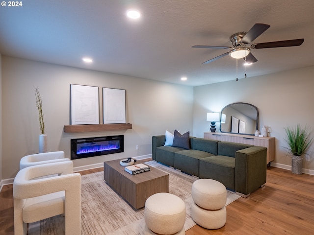 living room with light wood-type flooring and ceiling fan