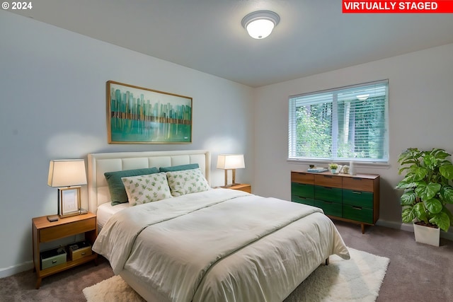 bedroom with baseboards and carpet