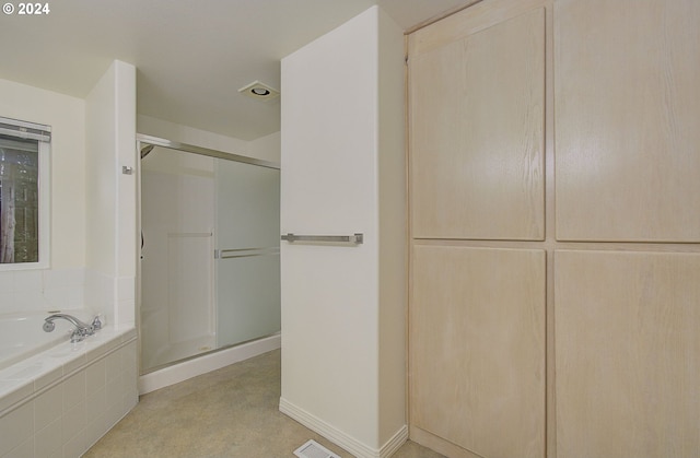 full bathroom featuring a bath, visible vents, a stall shower, and baseboards