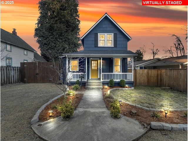 view of front of house featuring a yard and covered porch