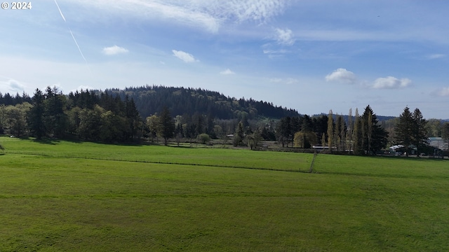 surrounding community featuring a rural view and a yard