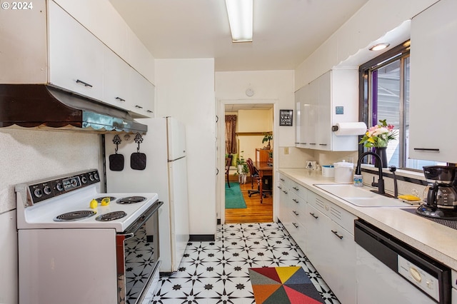 kitchen with light floors, white cabinets, a sink, white appliances, and under cabinet range hood