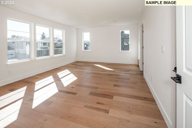 spare room featuring light wood-type flooring