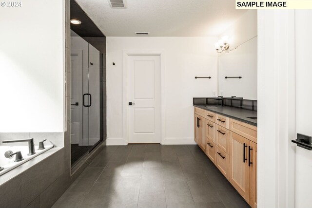 bathroom featuring tile patterned flooring, vanity, and separate shower and tub