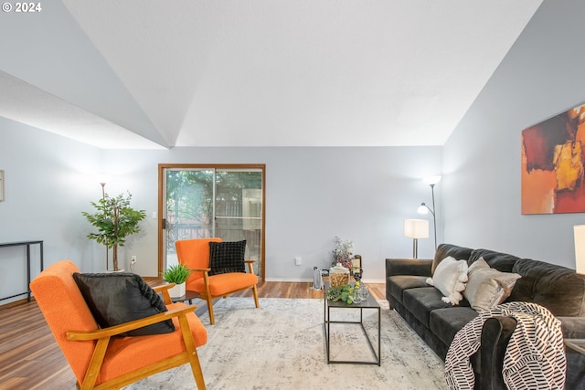 living room with hardwood / wood-style flooring and high vaulted ceiling