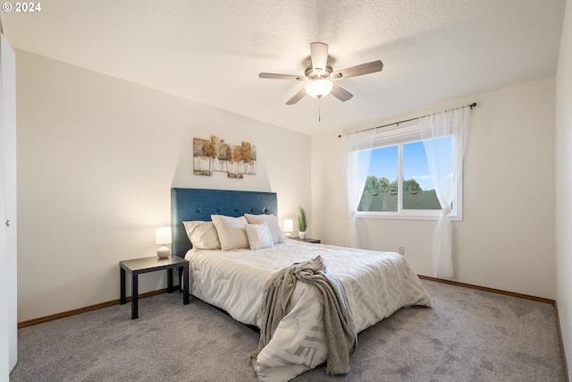 carpeted bedroom with a textured ceiling and ceiling fan