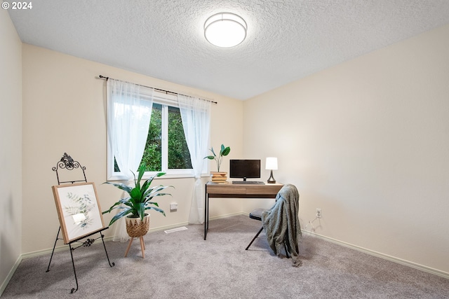 home office featuring carpet floors and a textured ceiling