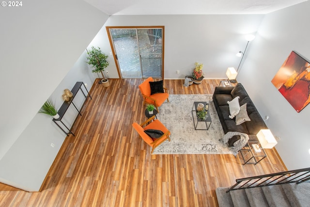 living room featuring hardwood / wood-style flooring and lofted ceiling