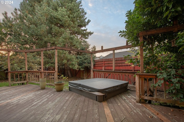 wooden deck featuring a covered hot tub