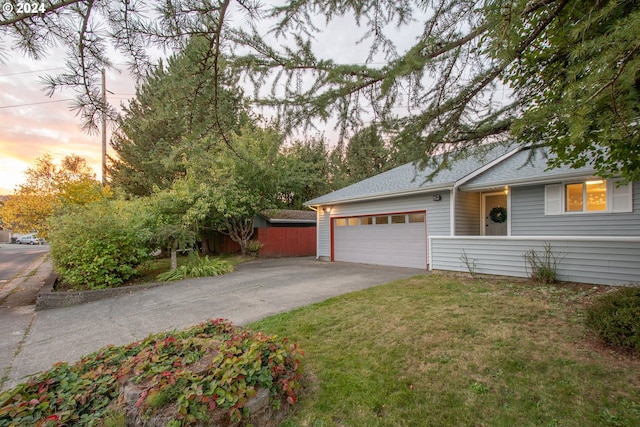 view of front of property featuring a garage and a yard