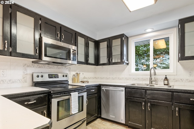 kitchen featuring stainless steel appliances, tasteful backsplash, and sink