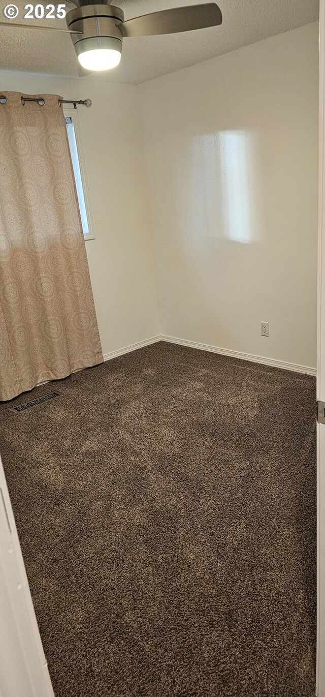 unfurnished room with carpet and ceiling fan