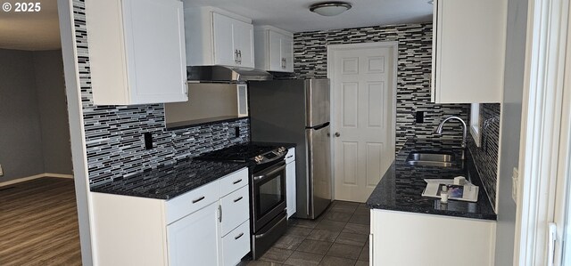 kitchen with sink, gas range, white cabinets, and decorative backsplash