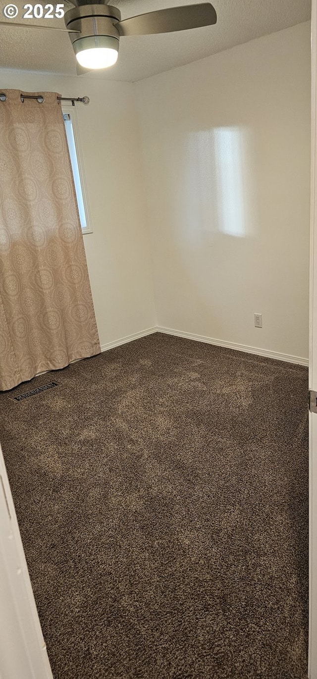 unfurnished room featuring ceiling fan and carpet floors