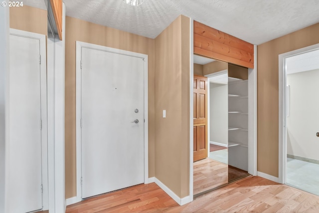 entryway featuring hardwood / wood-style flooring and a textured ceiling