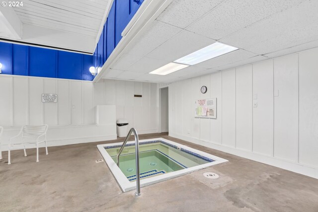 view of swimming pool featuring an indoor hot tub