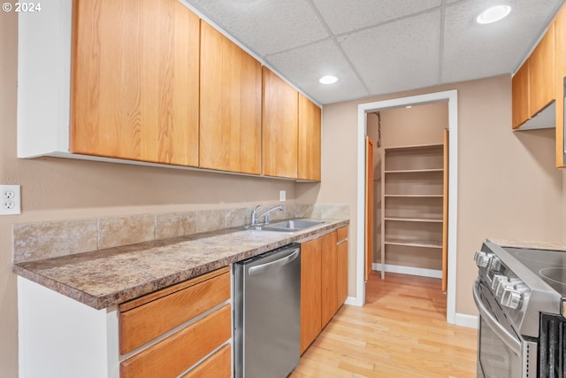 kitchen with a paneled ceiling, light hardwood / wood-style floors, sink, and appliances with stainless steel finishes