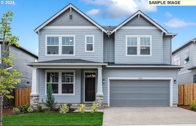 craftsman house featuring a garage and a front yard