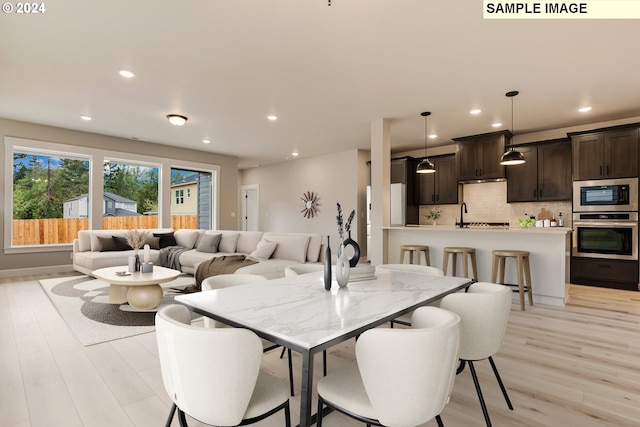 dining space with light hardwood / wood-style floors