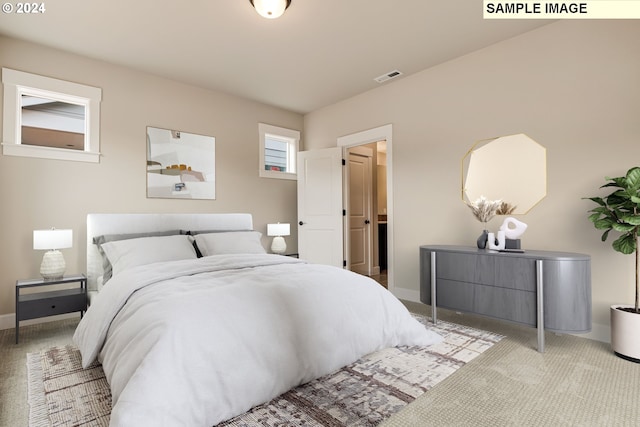 bedroom featuring light colored carpet