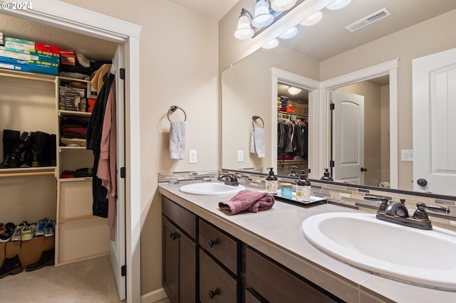 bathroom with tasteful backsplash and vanity