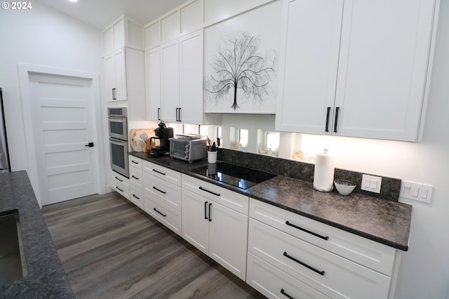 kitchen with black electric cooktop, dark stone countertops, white cabinetry, and dark hardwood / wood-style flooring