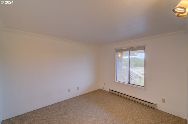 spare room with carpet, crown molding, and a baseboard heating unit