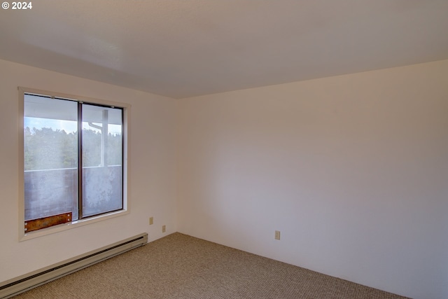 empty room with carpet flooring and a baseboard radiator