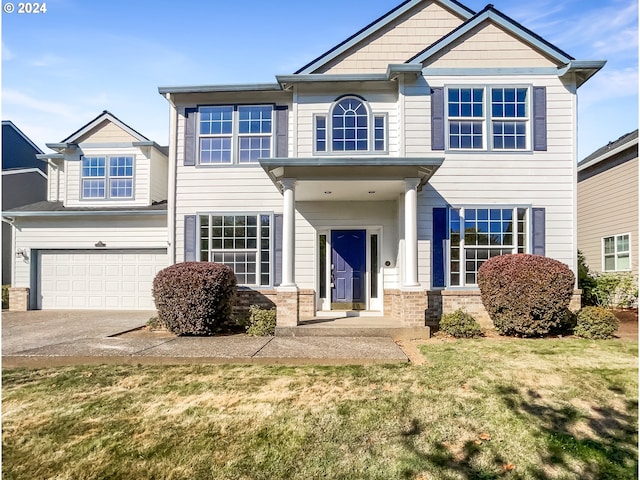 view of front facade with a front yard and a garage