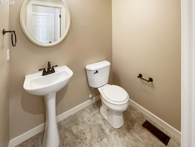 bathroom featuring tile patterned flooring, sink, and toilet