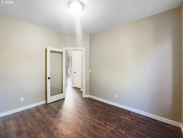 unfurnished room with dark hardwood / wood-style floors