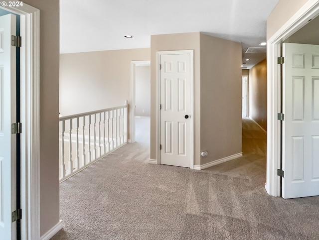 corridor featuring light colored carpet