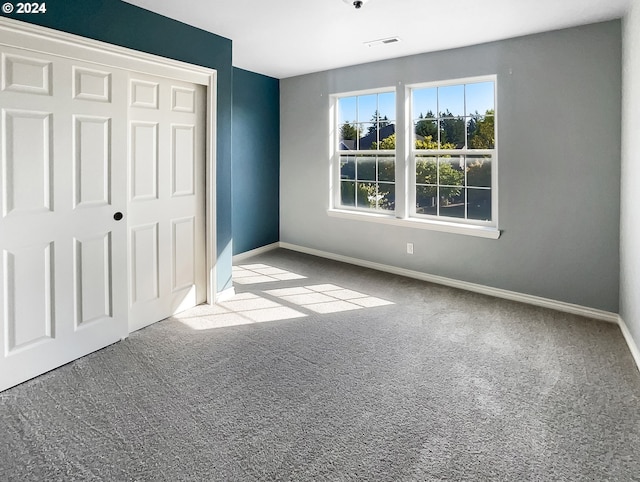 unfurnished bedroom with light carpet and a closet