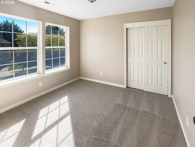 unfurnished bedroom featuring a closet and carpet flooring