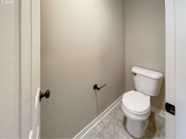 bathroom featuring tile patterned flooring and toilet