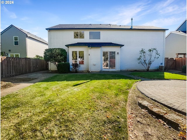 back of house featuring a yard and a patio area