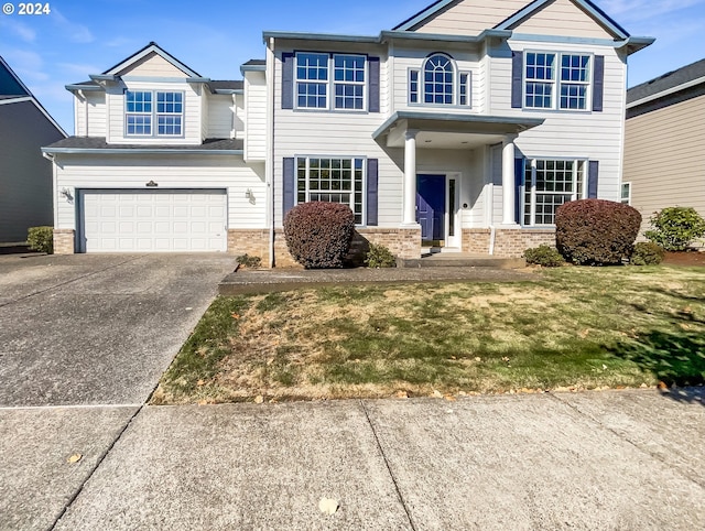 view of front of house with a front yard and a garage