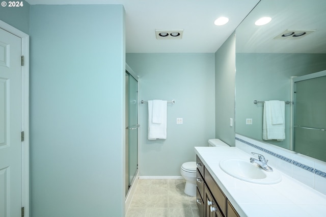 bathroom featuring walk in shower, vanity, and toilet