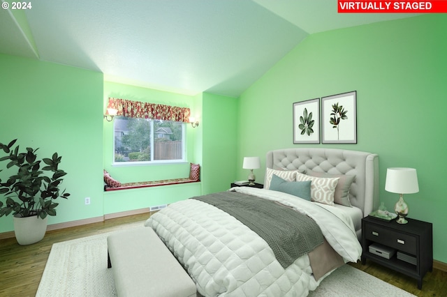 bedroom featuring lofted ceiling and hardwood / wood-style floors