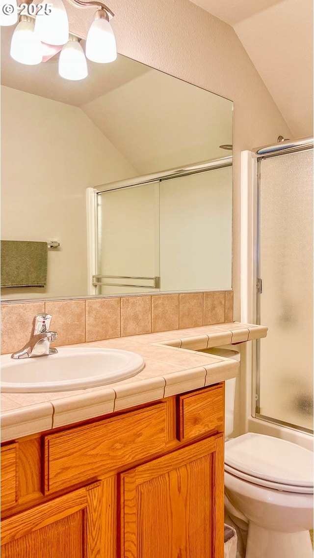 full bathroom with tasteful backsplash, toilet, combined bath / shower with glass door, vaulted ceiling, and vanity