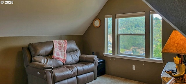 sitting room featuring lofted ceiling, plenty of natural light, and light carpet