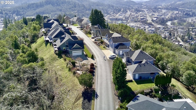 birds eye view of property featuring a residential view and a view of trees