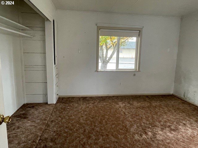 170 NE Exchange Ave, Roseburg, OR 97470 - unfurnished bedroom featuring carpet floors and a closet