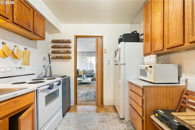 kitchen with decorative backsplash, white appliances, and light tile patterned floors