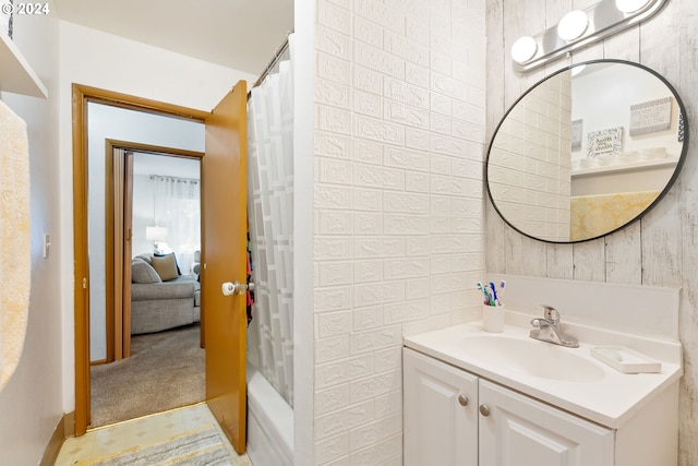 bathroom featuring vanity and shower / bathtub combination with curtain