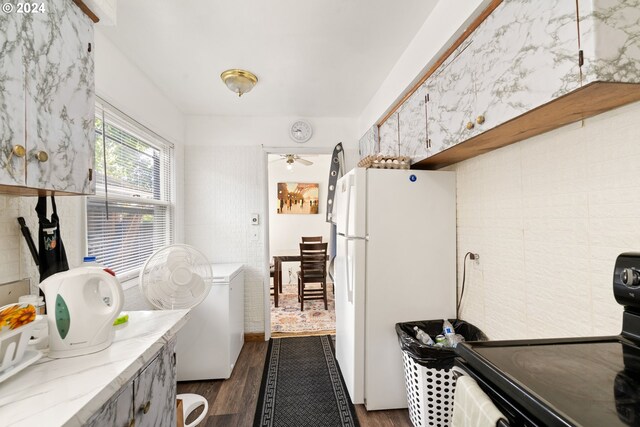 kitchen with electric range oven, ceiling fan, dark hardwood / wood-style floors, and white fridge